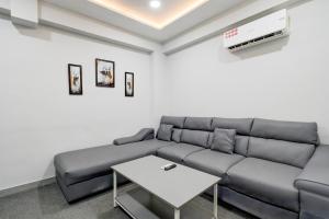 a living room with a couch and a table at Hotel O N Grand in Hyderabad