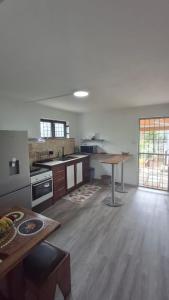 a large kitchen with a table in a room at Ti kaz Amater Cascavelle in Cascavelle