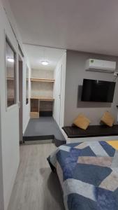 a bedroom with a bed and a room with shelves at Ti kaz Amater Cascavelle in Cascavelle