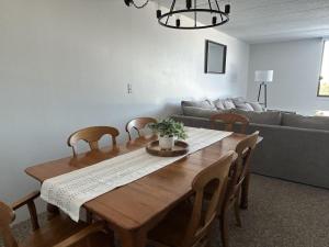 a living room with a wooden table and a couch at Amazing Lake Winni Views in Cedar Lodge Complex in Laconia