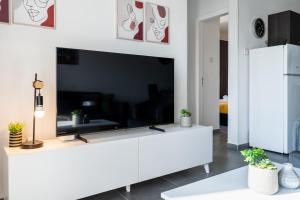 a living room with a large flat screen tv at Sonic 2-Bedroom Apartment in Larnaca