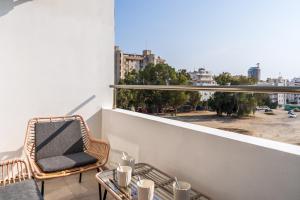 a balcony with a chair and a table and a window at Sonic 2-Bedroom Apartment in Larnaca