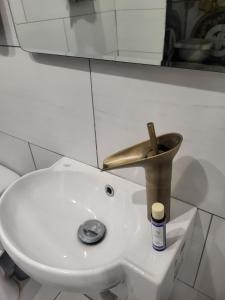 a bathroom sink with a faucet on top of it at Angelina's Home and Spa Alexandroupolis in Alexandroupoli