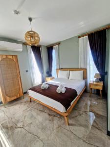 a bedroom with a bed with two towels on it at Velder House Urla in Urla +125 photos