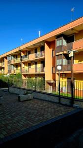 an apartment building with a fence in front of it at Nizzeti Home Catania Sicily Sea View in Aci Catena