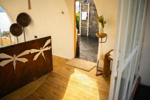 a hallway of a house with a wooden floor at Kisoro Art Island in Kisoro