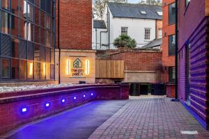 an empty alley with purple lights on the side of a building at The City Pad in Nottingham