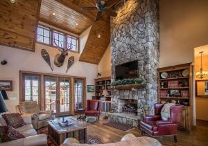 a large living room with a stone fireplace at Elk Camp Lodge in Linville
