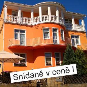 a orange building with a sign that reads quarantine v care at Pension Fami Retro Design in Staré Splavy
