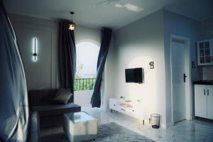 a living room with a couch and a window at Paradise House Holiday in Luxor