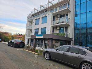 a gray car parked in front of a building at Студио за двама в Сарафово in Burgas City
