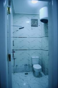 a white bathroom with a toilet and a sink at Paradise House Holiday in Luxor +46 photos
