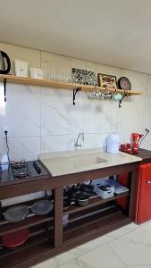 a kitchen with a sink and a stove in it at Garagem 36 próximo a Serra do Rio do Rastro in Louro Müller +21 photos
