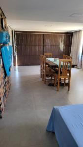 a dining room with a table and chairs at Garagem 36 próximo a Serra do Rio do Rastro in Louro Müller