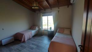 Ένα ή περισσότερα κρεβάτια σε δωμάτιο στο Casa en Estancias de Cafayate A38 +11 φωτογραφίες