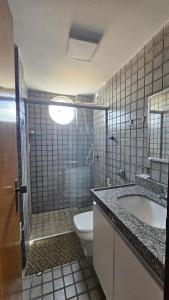 a bathroom with a shower and a toilet and a sink at Refúgio próximo ao mar in Cabedelo +14 photos