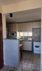 a kitchen with a stove and a counter top at Refúgio próximo ao mar in Cabedelo