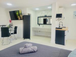 ein Schlafzimmer mit einem Bett und ein Badezimmer mit einem Waschbecken in der Unterkunft Kevin#B Chic Studio with Patio near Fort Lauderdale Beach in Fort Lauderdale