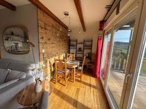 a living room with a table and a dining room at Le Panorama in Soultzeren