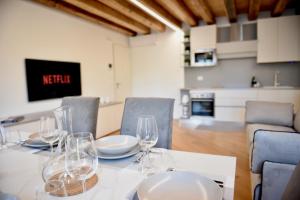 a dining room table with wine glasses on it at Udine Urban Nest in Udine