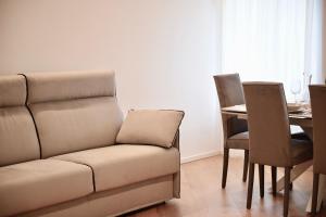 a living room with a couch and a table at Udine Urban Nest in Udine