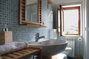 a bathroom with a sink and a toilet at Lumira Vista – Panorama in Sangineto +36 photos