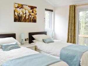 Ένα ή περισσότερα κρεβάτια σε δωμάτιο στο Ash Lodge