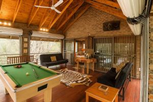 a living room with a pool table at Tree Lodge by My Adventure House in Marloth Park