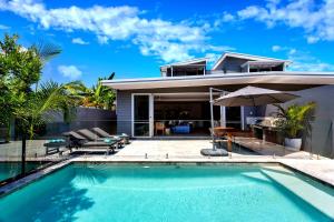a villa with a swimming pool and a house at Stonecutters 2 in Byron Bay