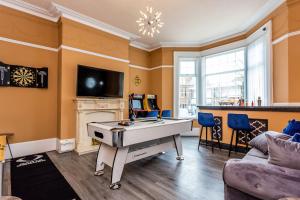 a living room with a ping pong table in it at Sandhaven House in South Shields