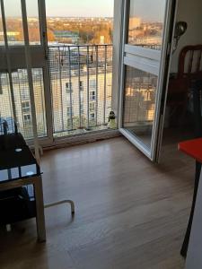 a room with a large window with a view of a city at Chambre simple proche de mairie Orly in Orly
