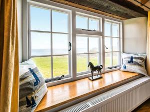 a window seat with a horse statue in front of it at Raddons - Uk50657 in Crackington Haven