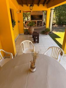 a table and chairs on a patio with a fireplace at La Regina Casa de Campo in La Caldera