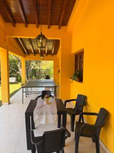 a patio with a table and chairs and a piano at La Regina Casa de Campo in La Caldera