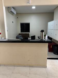 a kitchen with a counter top in a room at Brasil hotel in Canaã dos Carajás