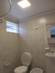 a bathroom with a toilet and a sink at La Casa de Mirna II in Formosa +2 photos