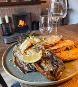 a plate of food with fish and bread on a table at The Five Bells Inn Accommodation in Claypole