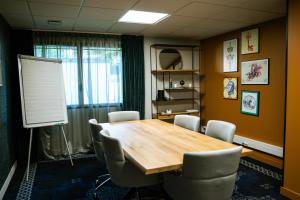 a conference room with a wooden table and chairs at Best Western Plus Le Conquerant Rouen Nord in Bois-Guillaume +142 photos
