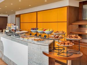 a buffet line with many plates of food at B&B HOTEL Alba in Alba