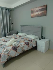 a bedroom with a bed and a nightstand and a bed sidx sidx sidx sidx at Breathtaking Studio Apartment in Marjan Island in Ras al Khaimah