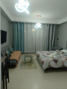 a bedroom with two beds and a couch and a table at Breathtaking Studio Apartment in Marjan Island in Ras al Khaimah +31 photos