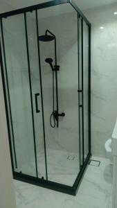 a shower with a glass door in a bathroom at Breathtaking Studio Apartment in Marjan Island in Ras al Khaimah