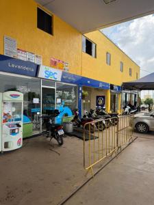a scooter parked in front of a gas station at Brasil hotel in Canaã dos Carajás