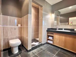 a bathroom with a toilet and a sink at Orchard Cottage in Willingham +9 photos