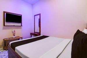 Ένα ή περισσότερα κρεβάτια σε δωμάτιο στο Hotel O Vedika Acropolis Mall