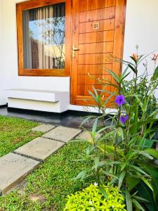 a wooden door of a house with a flower at The Opulent Retreat in Ahangama +22 photos