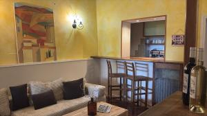 a living room with a couch and a bar at Hotel De Provence in Digne-les-Bains