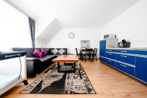 a living room with a couch and a table at Hotel Bären in Hechingen