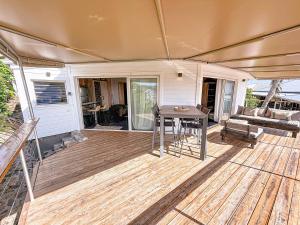 a patio with a table and a couch at Villa Olive Sea View Cocoon in Oyster Pond in Oyster Pond