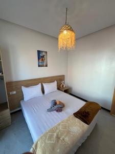 a bedroom with a bed with a person laying on it at Atlantic view Tamraght 1 in Tamraght Oufella